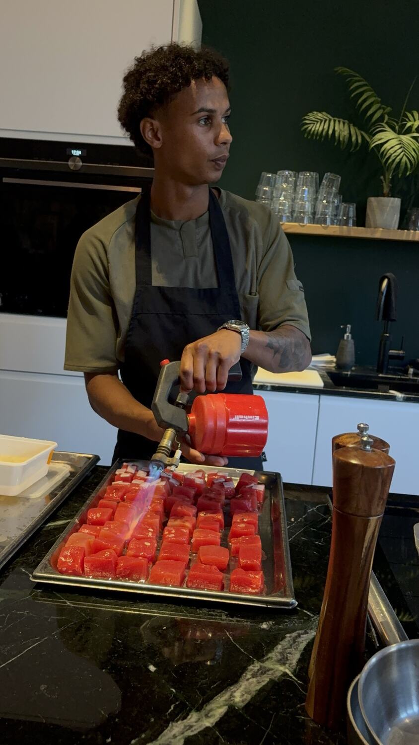 Eef Kwakman brandt blokjes watermeloen af met een brander